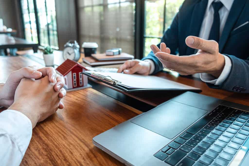 A mortgage broker in a meeting with a housebuyer applying for a home loan