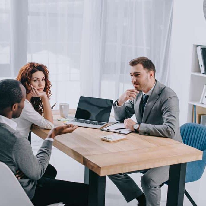 A couple asking a mortgage broker a question.