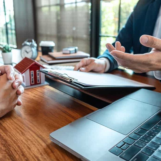 A mortgage broker in a meeting with a housebuyer applying for a home loan