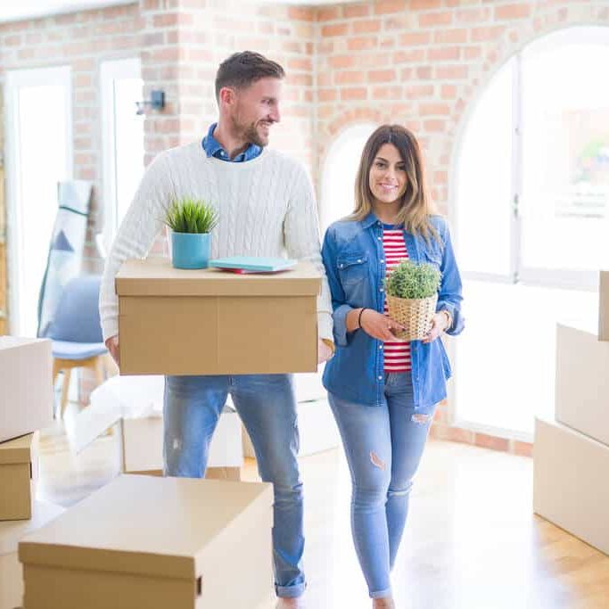 A young couple moving into their first home