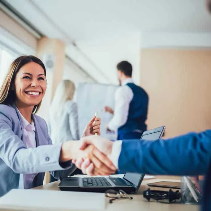 A local mortgage broker shaking hands with a client.
